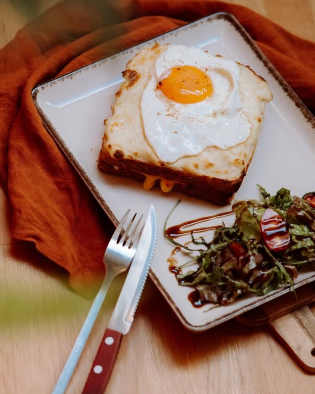 A brunch plate with eggs, toast and salad