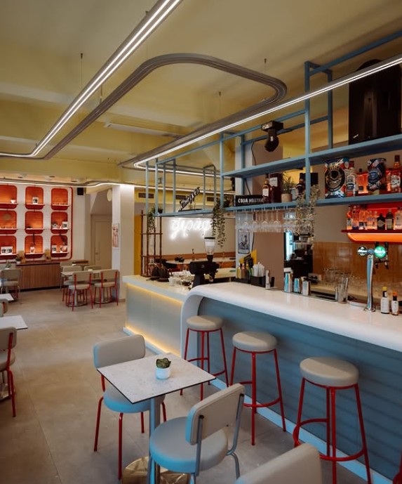 The yellow, retro-inspired interior of Tziraf cafe-bar