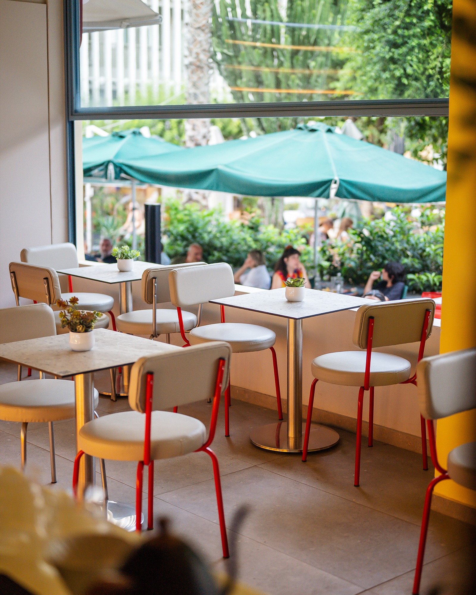 Warm yellow seating and retro-inspired details inside Tziraf